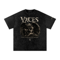 A black acid-wash graphic t-shirt featuring a sepia-toned illustration of a winged, kneeling figure with the text 'VXCES' and 'LEAVE YOUR OLD VICES BEHIND.' on the front.