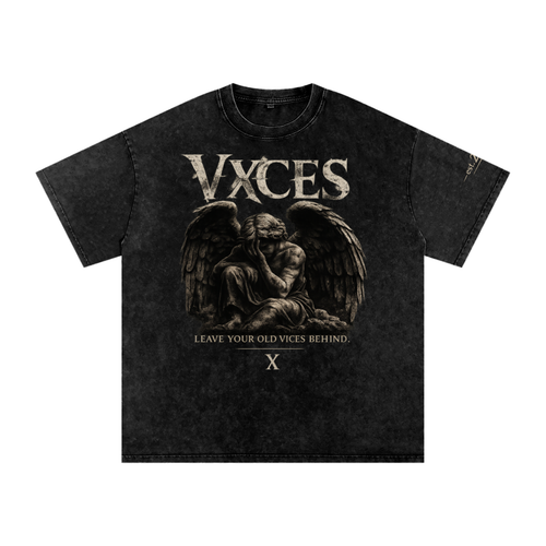 A black acid-wash graphic t-shirt featuring a sepia-toned illustration of a winged, kneeling figure with the text 'VXCES' and 'LEAVE YOUR OLD VICES BEHIND.' on the front.